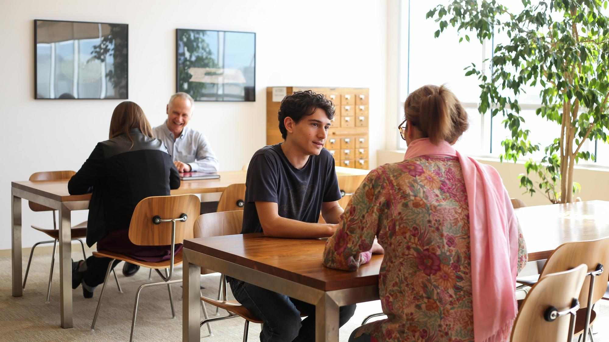 Photo of people in CIIS' Laurance Rockefeller Library