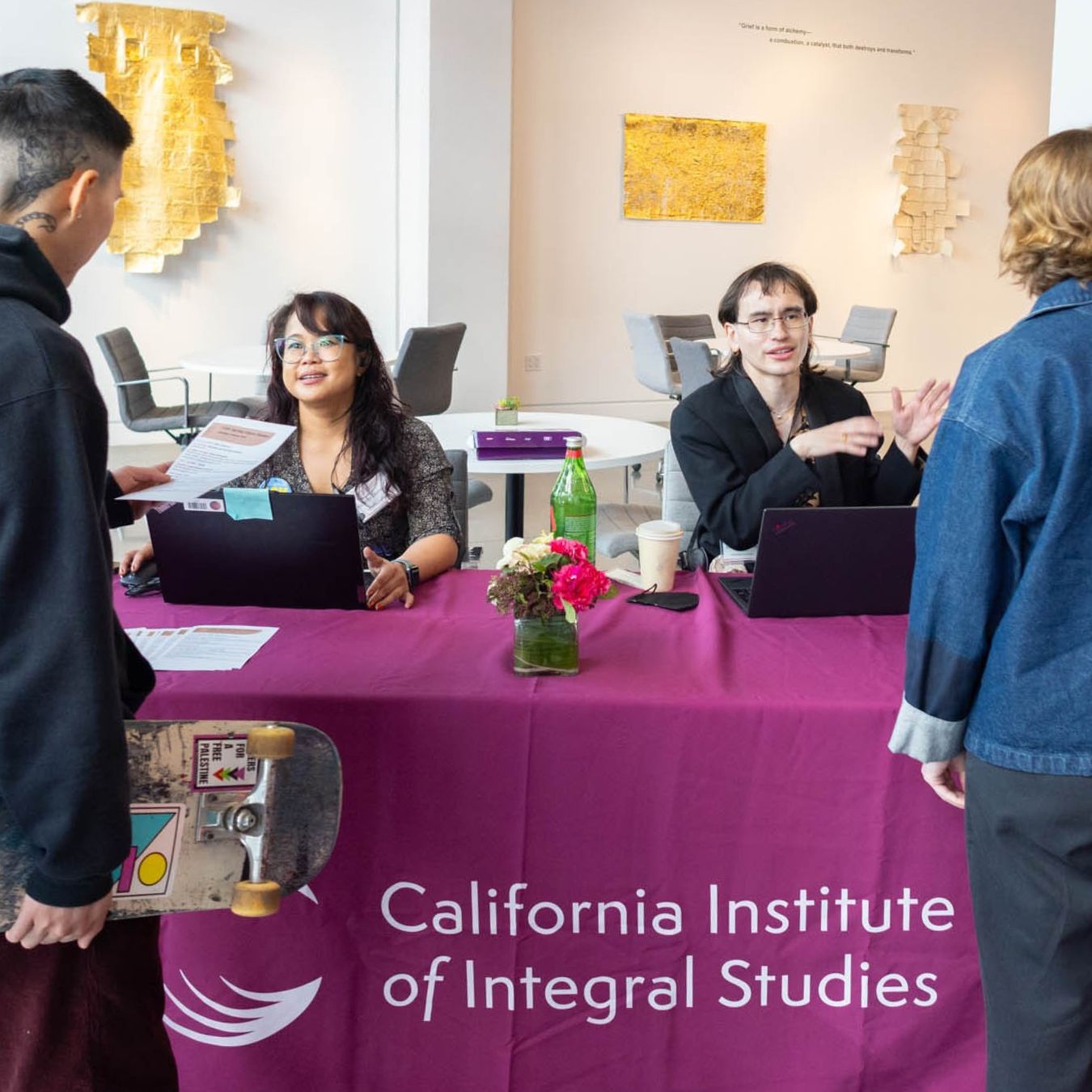Two CIIS admissions counselors assist with registration