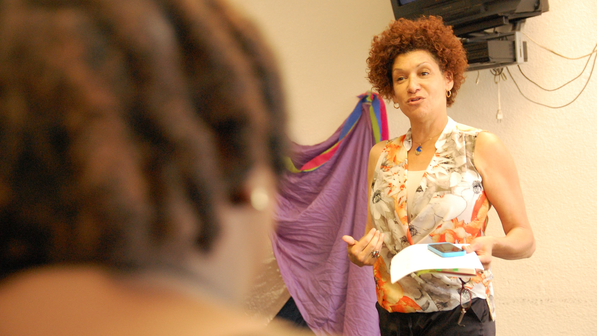 Action shot of Myriam (Mimi) Savage speaking in a classroom