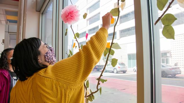 Student putting up a flower