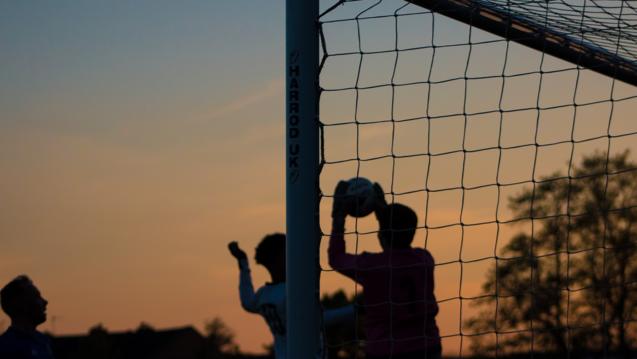 Community playing soccer by David Clarke