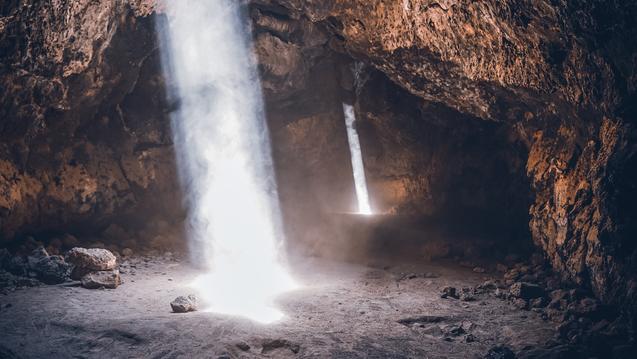 Light shining through holes in a cave