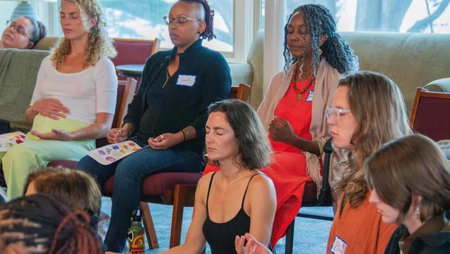 Photo of a diverse group of women sitting in medition