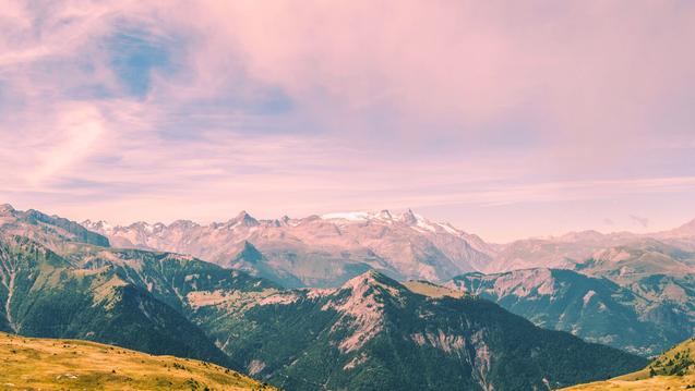 Photo of a mountain landscape with pink sky