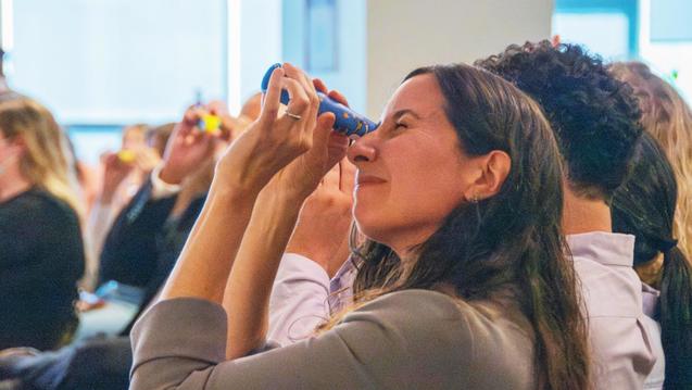 Photo of a woman looking through a kaleidoscope