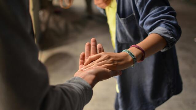 Photo of outreached holding hands
