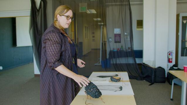 Woman looking at items on table