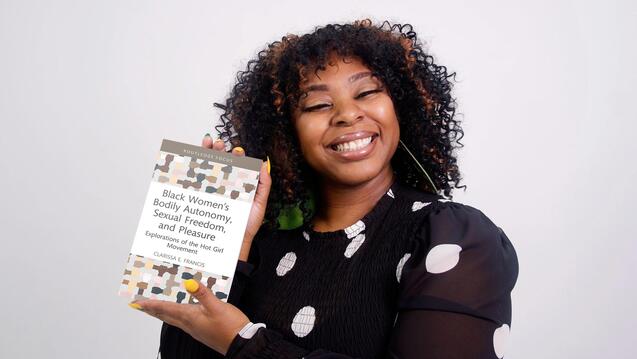 Image of Clarissa Francis holding up her book