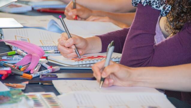 Students taking note in a classroom.