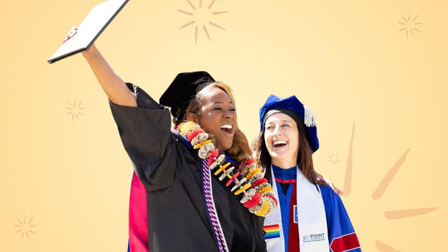Graduate holding up diploma with professor