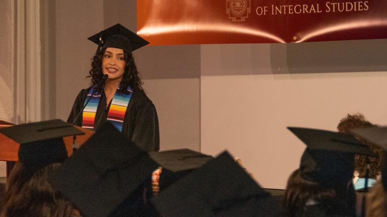 Student speaking at CIIS' 2022 Commencement Ceremony