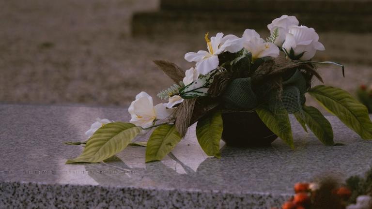 Associated Press Image of white flowers laid on the ground.