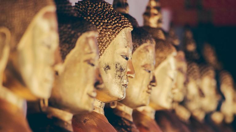 Row of gold Buddha heads