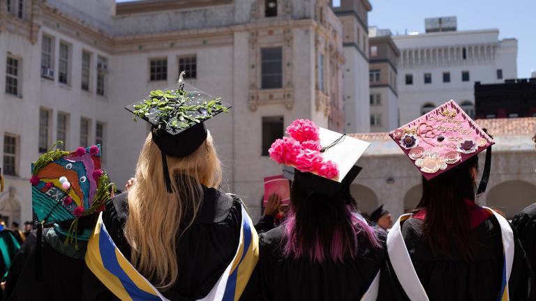 Graduates decorating motorboards at graduation