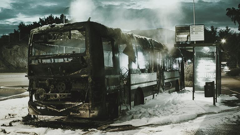 Apocalyptic photo of burnt bus and bus stop
