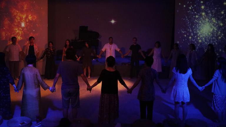 Drama Therapy students standing in a circle while holding hands. Find out more about the Master of Art in Counseling Psychology with concentration in Drama Therapy at California Institute of Integral Studies, CIIS, in San Francisco, CA.