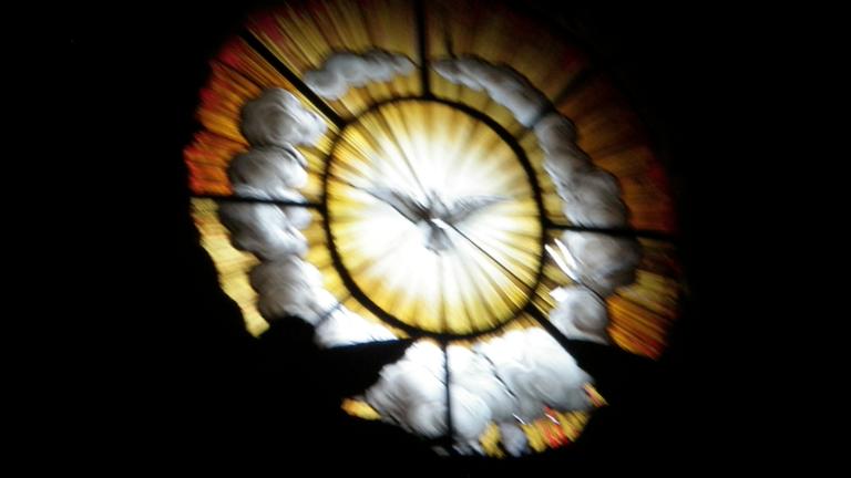 Image of a window decorated with a flying dove. Learn more about the Women's Spirituality online MA and PhD programs at California Institute of Integral Studies, CIIS. 