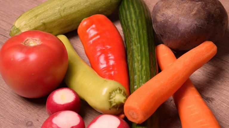 Vegetables on a wooden table.  Find out more about the Integrative Health online M.A. program at California Institute of Integral Studies (CIIS)