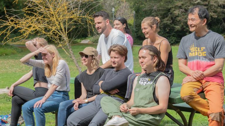 Group of students sitting on a picnic table