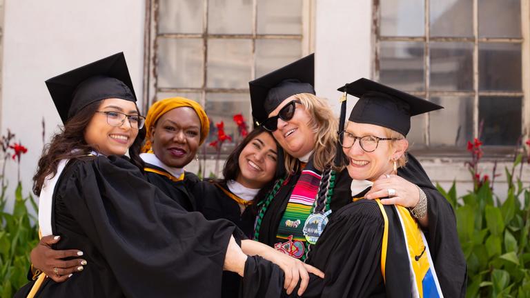 Graduates hugging each othere