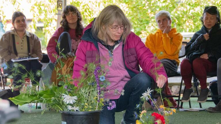 Photo of woman contributing to earth altar 