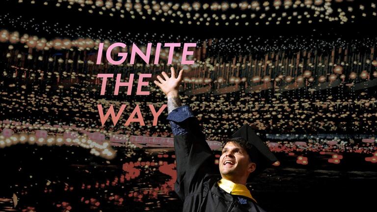 commencement grad raising hand