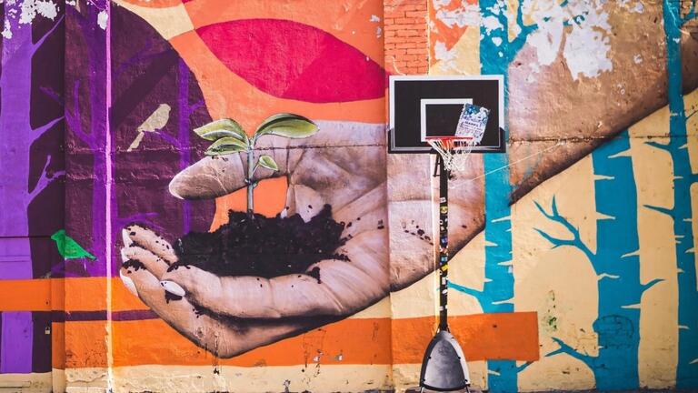 Mural of a hand holding soil