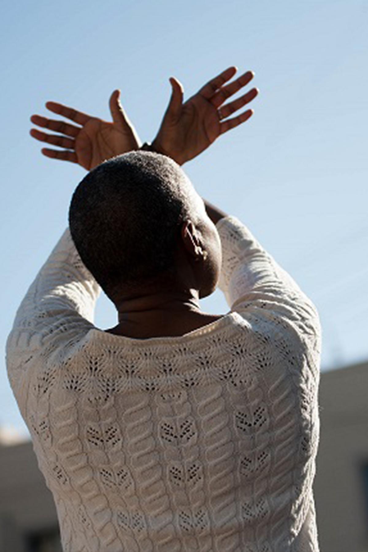 Black woman doing qi gong