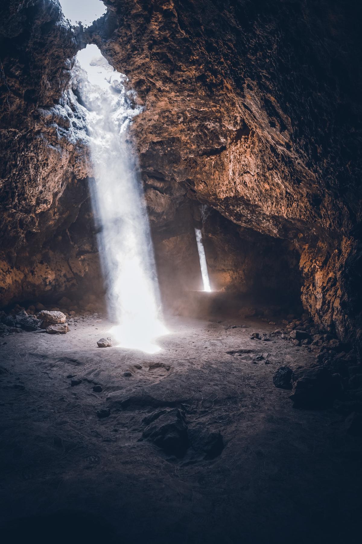 Light shining through holes in a cave