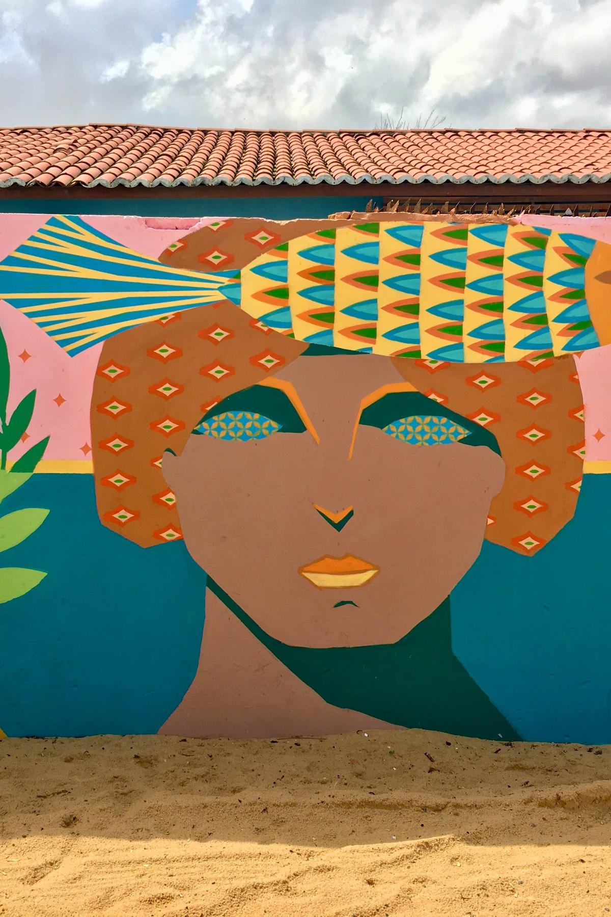 Colorful mural on a wall of a person with a fish