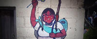Liberación--painting of a girl holding up her arm in resistance in the autonomous Zapatista territory in Chiapas, Mexico.