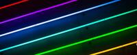 Stripes of rainbow neon lights on a black background. Find out more about Human Sexuality and the Lavender Languages conference at CIIS. 