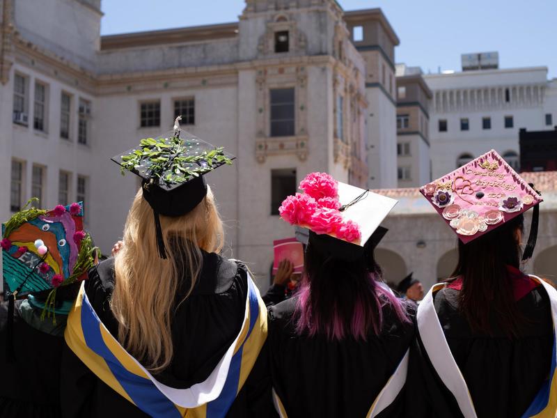 Graduates decorating motorboards at graduation