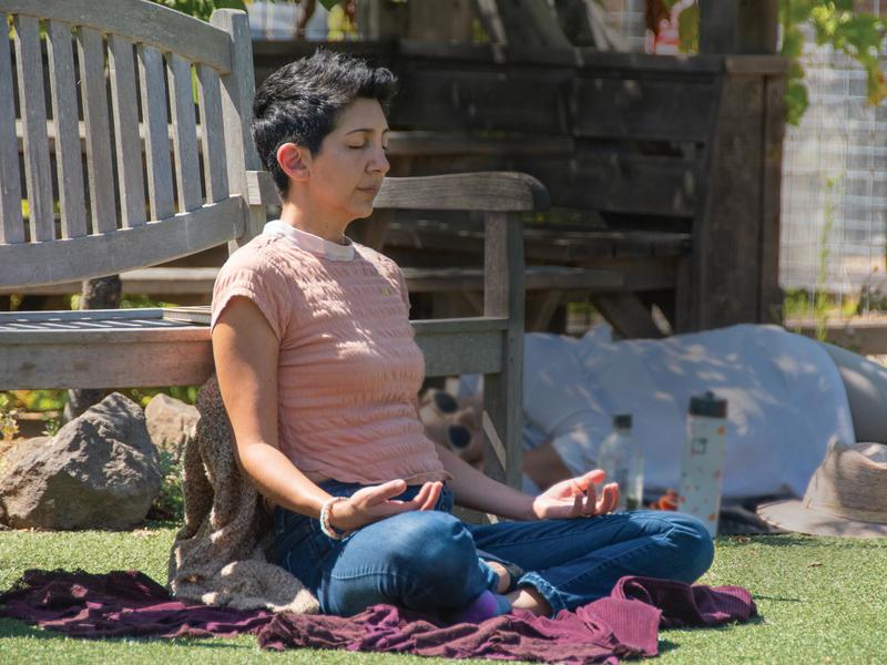 Photo of a person meditating in a park